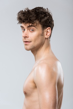 portrait of handsome young brunette man isolated on greyの写真素材