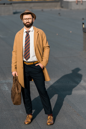 adult confident businessman standing with hand in pocket on roofの写真素材