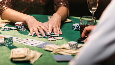 cropped image of girl taking poker chips at casino tableの写真素材