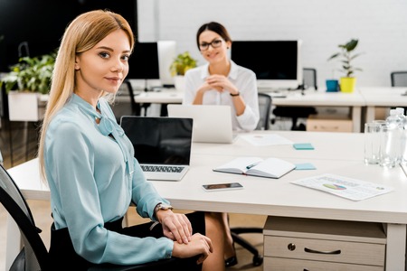 businesswomen at workplace with laptops in office