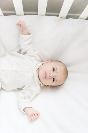 overhead view of adorable baby in crib