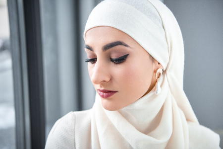 portrait of beautiful pensive young muslim woman looking downの写真素材