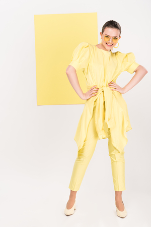 beautiful stylish girl in sunglasses posing with limelight on backgroundの写真素材