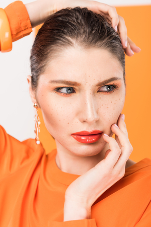 beautiful fashionable young woman posing with tumeric on backgroundの写真素材