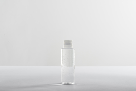Cosmetic bottle with transparent liquid on white background with copy spaceの写真素材