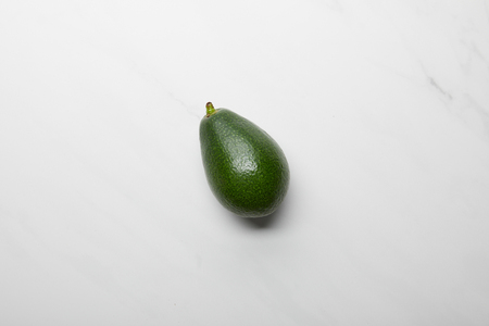 top view of whole avocado on grey textured backgroundの写真素材