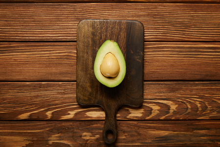top view of cut avocado on wooden  backgroundの写真素材