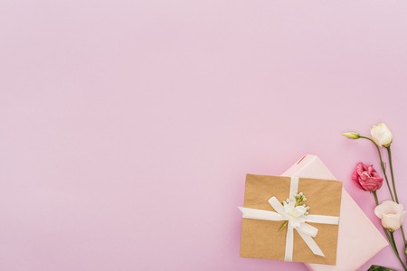 top view of gift boxes and flowers isolated on pink with copy spaceの写真素材