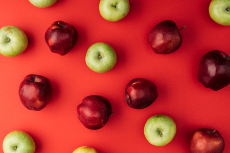 top view of delicious large multicolored apples on red backgroundの写真素材