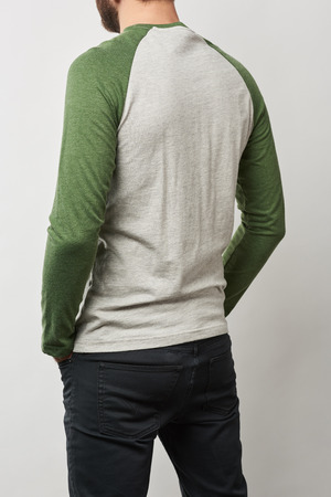 partial view of man in raglan sleeve baseball shirt with copy space isolated on greyの写真素材