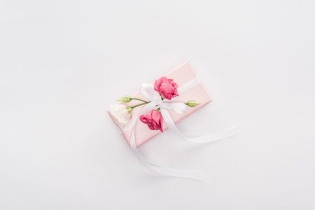top view of gift box with ribbon and flowers isolated on whiteの写真素材