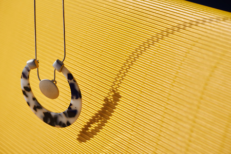 beautiful luxury necklace on yellow striped surfaceの写真素材