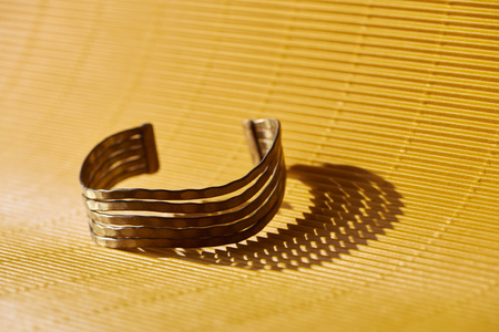 beautiful luxury bracelet on yellow striped surfaceの写真素材