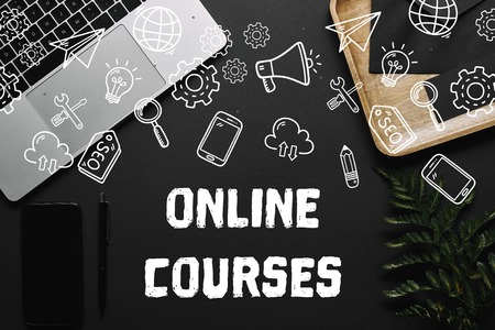 Smartphone and laptop on black background with "online survey" lettering and iconsの写真素材