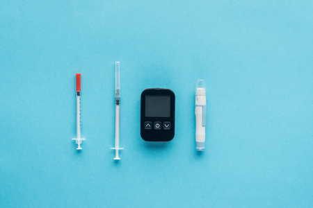 flat lay of medical equipment for diabetes control on blue backgroundの写真素材
