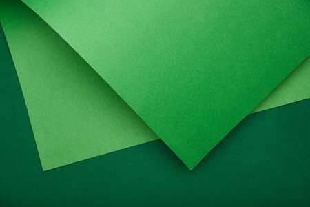 view from above of green paper on colored backgroundの写真素材
