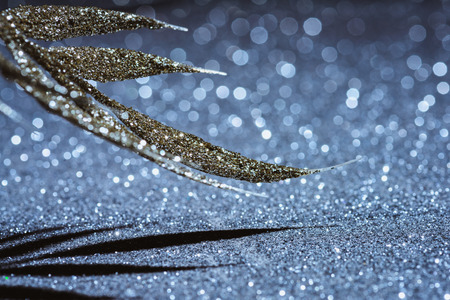 selective focus of festive branch decorated by golden glitter, christmas background conceptの写真素材