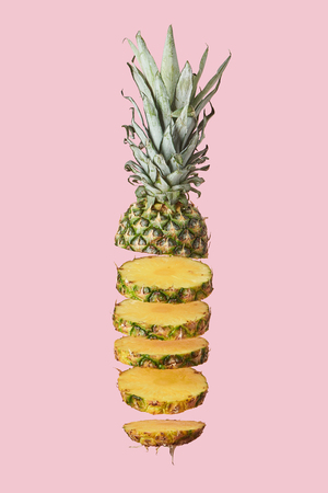 sliced sweet organic pineapple isolated on pinkの写真素材