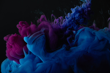 abstract dark texture with blue and purple swirls of paintの写真素材