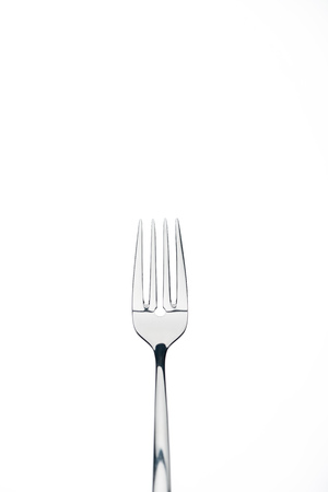 four-prong metal shiny fork isolated on white isolated on whiteの写真素材