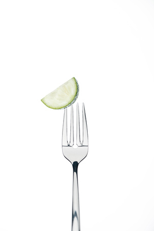 half slice of fresh ripe cucumber on fork isolated on whiteの写真素材