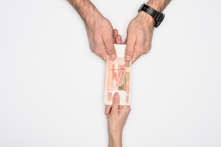 partial view of man and woman holding together Russian banknote isolated on greyの写真素材