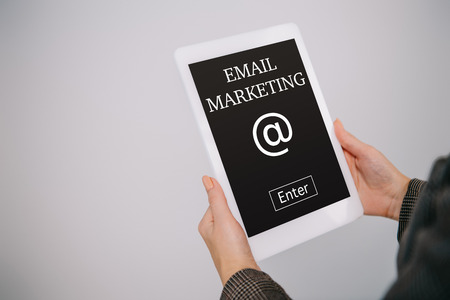 cropped view on businesswoman using digital tablet with email marketing isolated on greyの写真素材