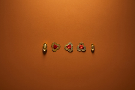 top view of traditional golden chinese decorations on brown backgroundの写真素材