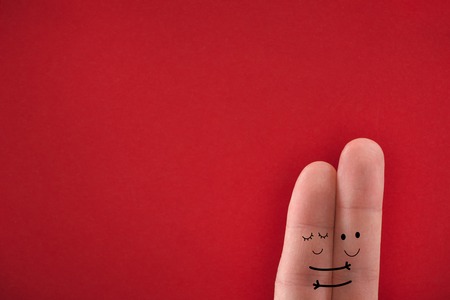 Painted fingers pretending happy couple in love hugging. Valentines day concept.の写真素材