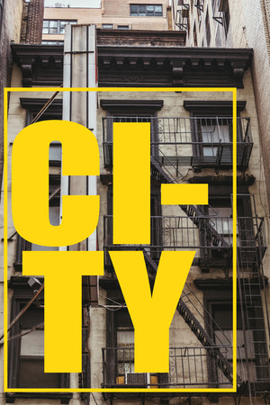 urban scene with old building in new york with yellow "city" lettering in frame, usaの写真素材