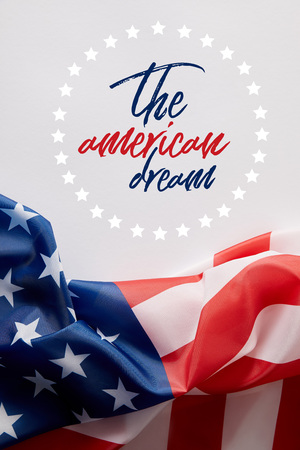 top view of united states of america flag and the american dream lettering on white surfaceの写真素材