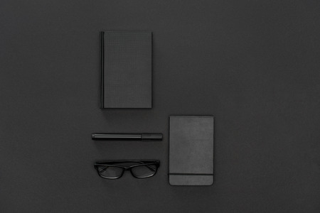 Top view of notebooks, pen and glasses