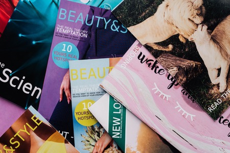 top view of pile of different tabloid magazines on surfaceの写真素材