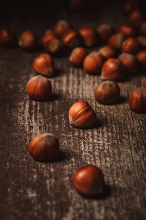 close up view of shelled hazelnuts on wooden tabletopの写真素材