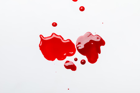 top view of red spilled  nail polish isolated on greyの写真素材
