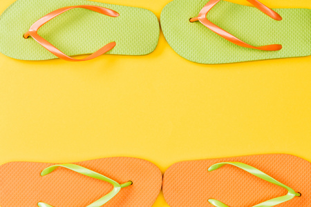 top view of flip flops on yellow backgroundの写真素材