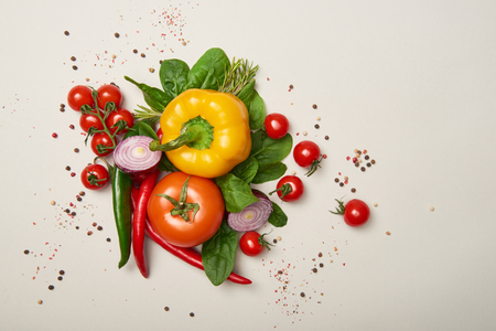 Top view of fresh vegetables and spices on grey backgroundの写真素材