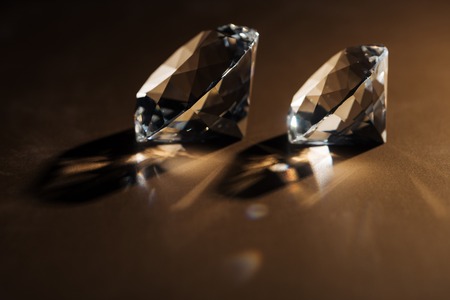 sparkling clear diamonds on brown background with copy spaceの写真素材