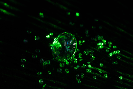 collection of diamonds with bright green neon light on dark backgroundの写真素材
