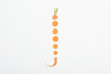 top view of fresh raw ripe carrot slices arranged in vertical row isolated on white