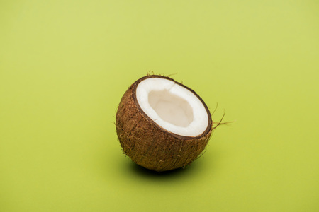 Half of ripe fresh coconut on green backgroundの写真素材