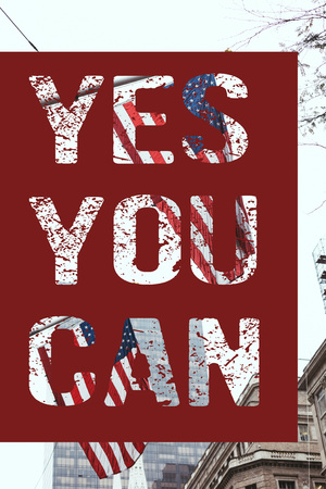 urban scene with national american flags on street and "yes you can" lettering, new york, usaの写真素材