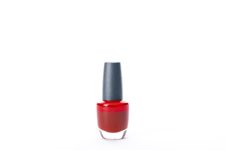bottle of shiny red nail polish isolated on whiteの写真素材