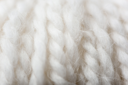 full frame of white knitting texture as backdropの写真素材