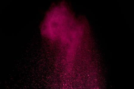 Pink holi powder in air on black backgroundの写真素材