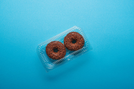 top view of chocolate donuts on blue background
