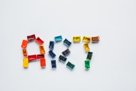 top view of art lettering made of paints on white backgroundの写真素材