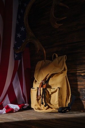 backpack, horns and american flag on wooden surface, travel conceptの写真素材