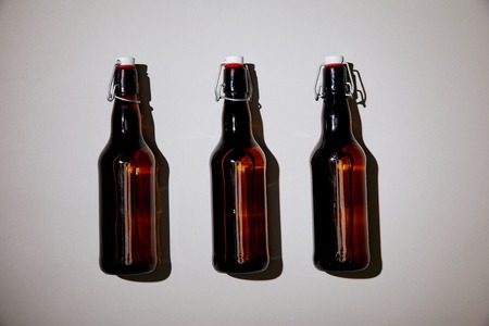brown bottles with beer on white backgroundの写真素材