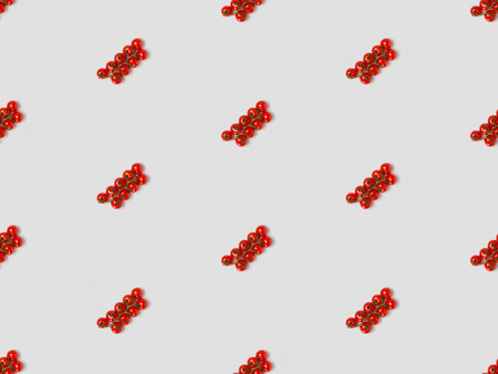 collage of cherry tomatoes on grey background, seamless background patternの写真素材
